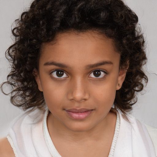 Joyful white child female with medium  brown hair and brown eyes