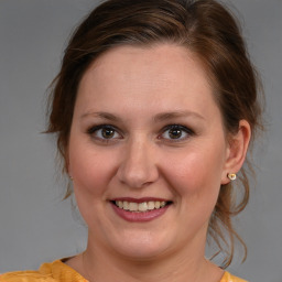 Joyful white young-adult female with medium  brown hair and brown eyes