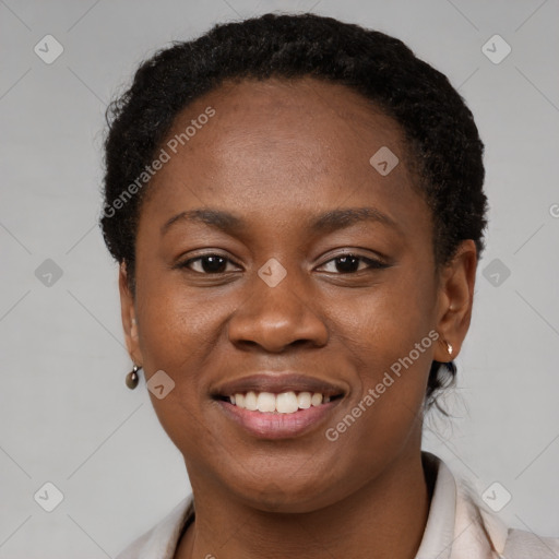 Joyful black young-adult female with short  brown hair and brown eyes