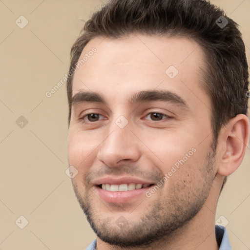 Joyful white young-adult male with short  brown hair and brown eyes