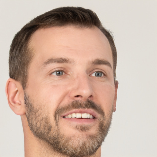 Joyful white adult male with short  brown hair and brown eyes