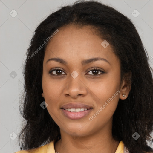 Joyful black young-adult female with long  brown hair and brown eyes