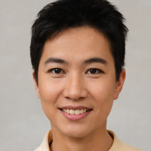 Joyful asian young-adult male with short  black hair and brown eyes