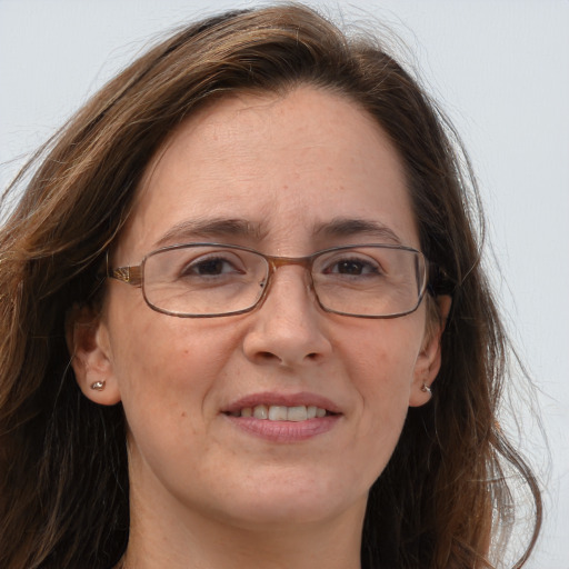 Joyful white adult female with long  brown hair and brown eyes