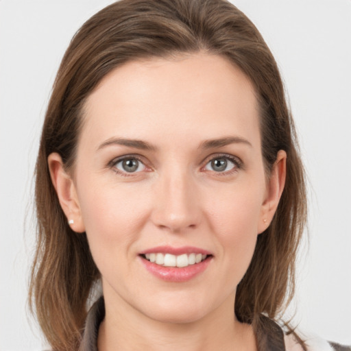 Joyful white young-adult female with medium  brown hair and grey eyes