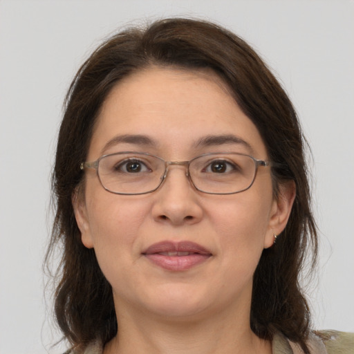 Joyful white adult female with medium  brown hair and grey eyes