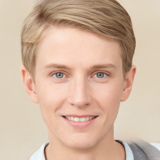 Joyful white young-adult male with short  brown hair and blue eyes