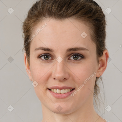 Joyful white young-adult female with short  brown hair and grey eyes