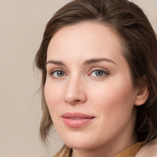 Joyful white young-adult female with long  brown hair and blue eyes