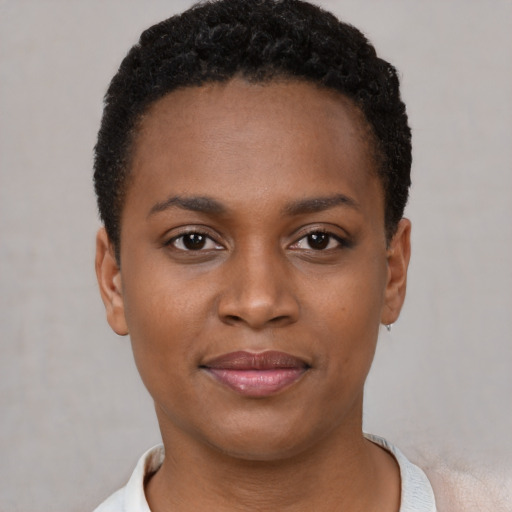 Joyful black young-adult female with short  brown hair and brown eyes