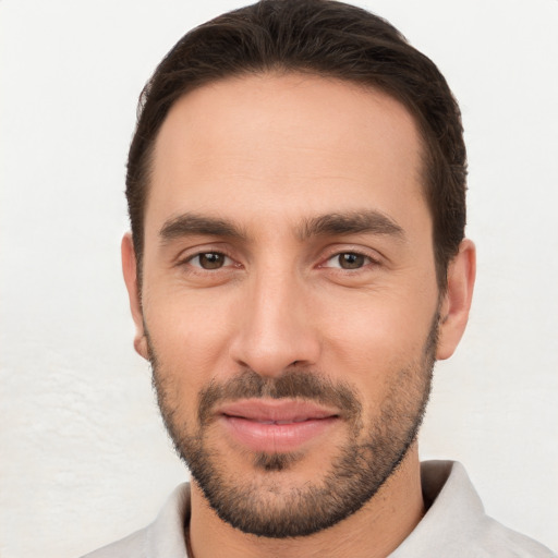 Joyful white young-adult male with short  brown hair and brown eyes