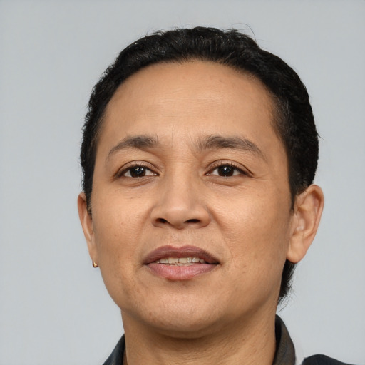 Joyful latino adult male with short  brown hair and brown eyes
