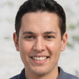 Joyful white adult male with short  brown hair and brown eyes