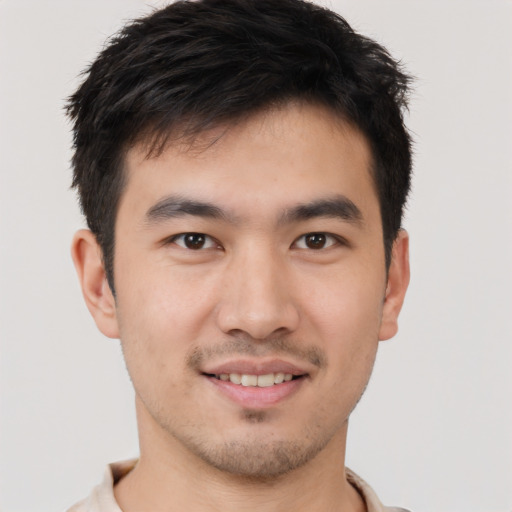 Joyful asian young-adult male with short  brown hair and brown eyes