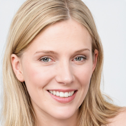 Joyful white young-adult female with long  brown hair and blue eyes