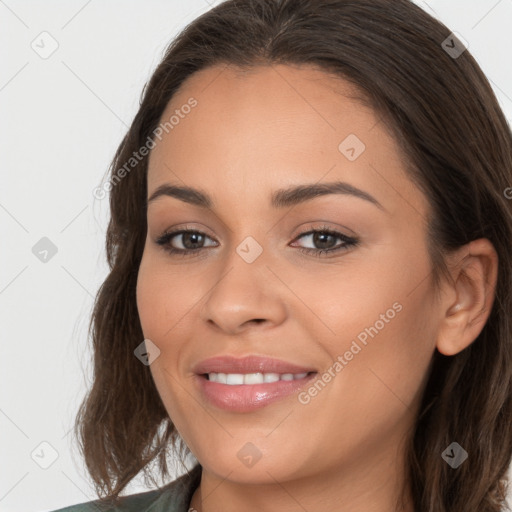 Joyful white young-adult female with long  brown hair and brown eyes