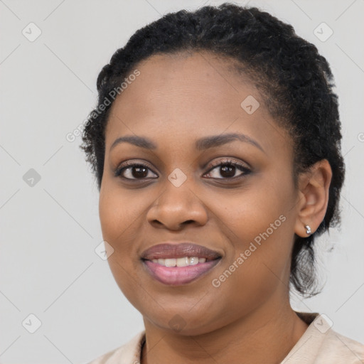 Joyful black young-adult female with short  black hair and brown eyes