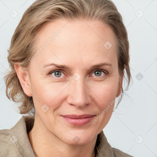 Joyful white adult female with medium  brown hair and blue eyes