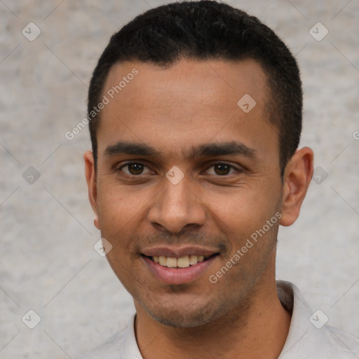 Joyful latino young-adult male with short  black hair and brown eyes