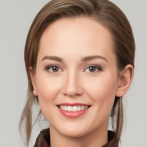 Joyful white young-adult female with long  brown hair and grey eyes