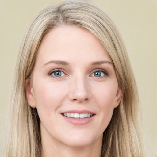 Joyful white young-adult female with long  brown hair and blue eyes