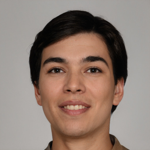 Joyful white young-adult male with short  black hair and brown eyes