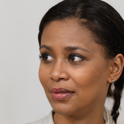 Joyful black young-adult female with medium  brown hair and brown eyes