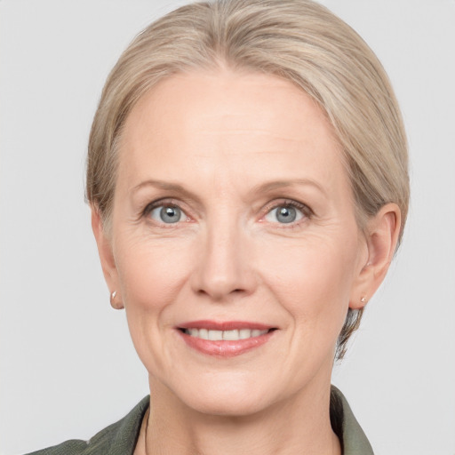 Joyful white adult female with medium  brown hair and grey eyes