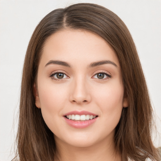 Joyful white young-adult female with long  brown hair and brown eyes