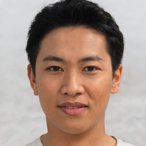 Joyful asian young-adult male with short  black hair and brown eyes