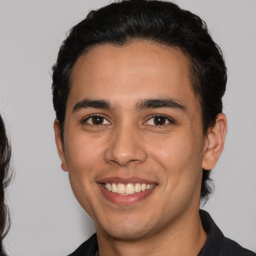 Joyful white young-adult male with medium  brown hair and brown eyes