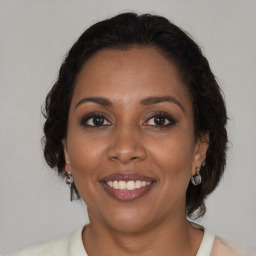 Joyful black adult female with medium  brown hair and brown eyes