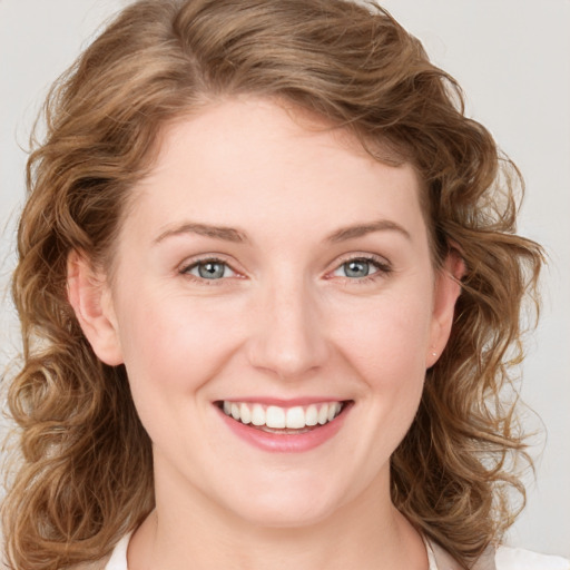 Joyful white young-adult female with medium  brown hair and blue eyes