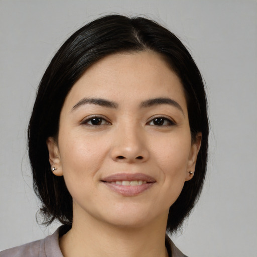 Joyful white young-adult female with medium  black hair and brown eyes
