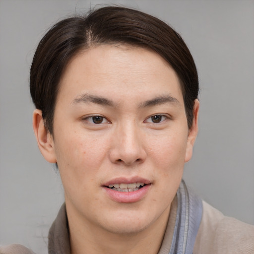 Joyful asian young-adult male with short  brown hair and brown eyes