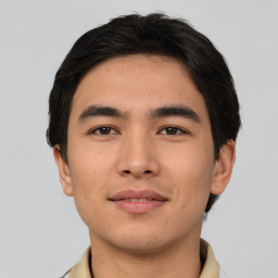 Joyful asian young-adult male with short  black hair and brown eyes