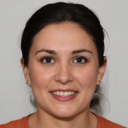 Joyful white adult female with medium  brown hair and brown eyes