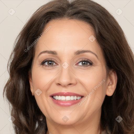 Joyful white adult female with long  brown hair and brown eyes