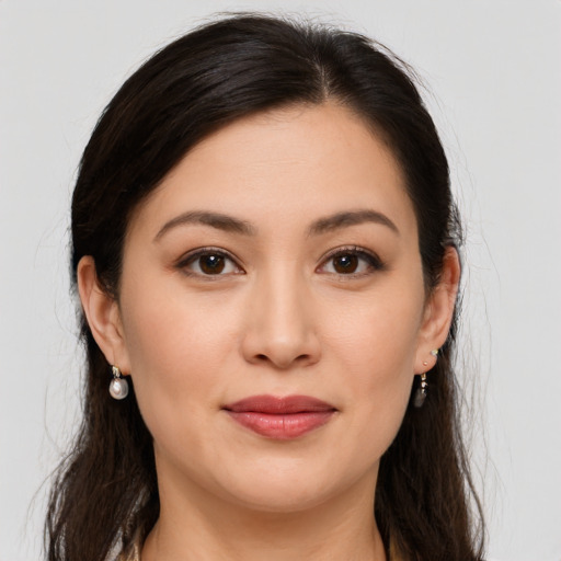 Joyful white young-adult female with long  brown hair and brown eyes