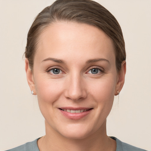 Joyful white young-adult female with short  brown hair and grey eyes