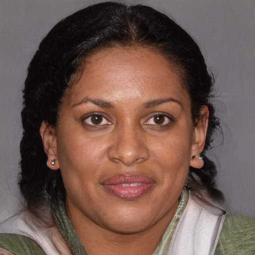 Joyful black adult female with medium  brown hair and brown eyes