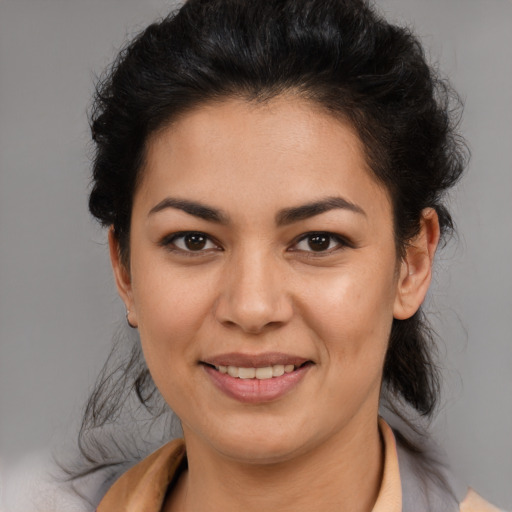 Joyful latino young-adult female with medium  brown hair and brown eyes