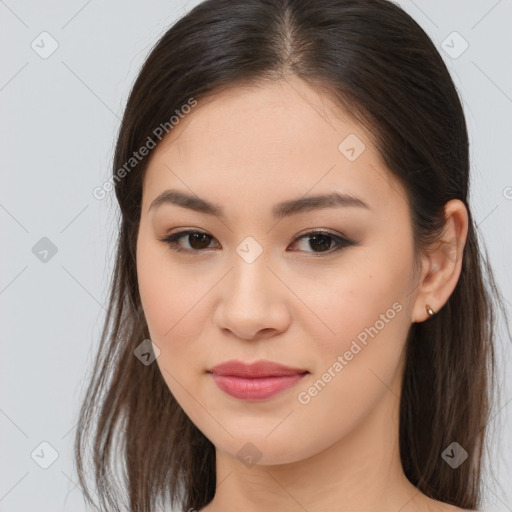 Joyful asian young-adult female with long  brown hair and brown eyes