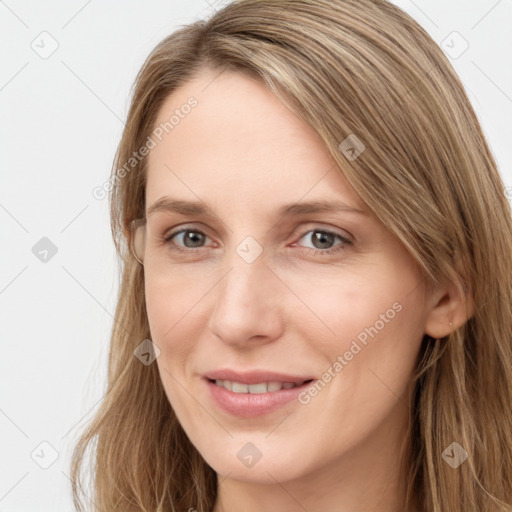 Joyful white young-adult female with long  brown hair and grey eyes