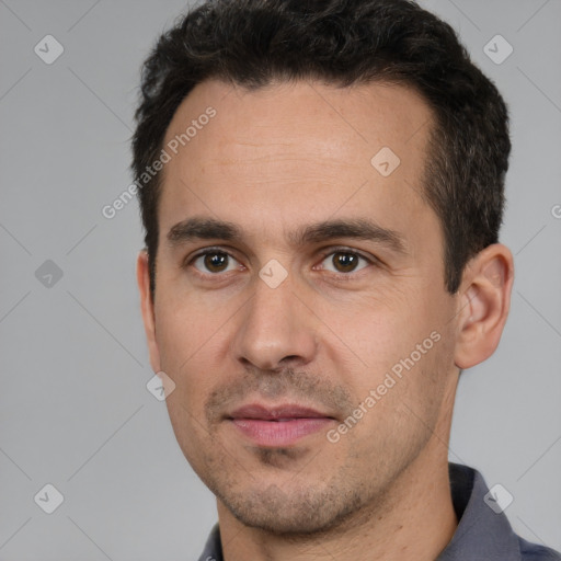 Joyful white young-adult male with short  black hair and brown eyes