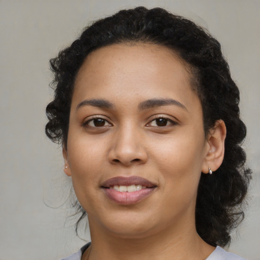 Joyful latino young-adult female with medium  black hair and brown eyes