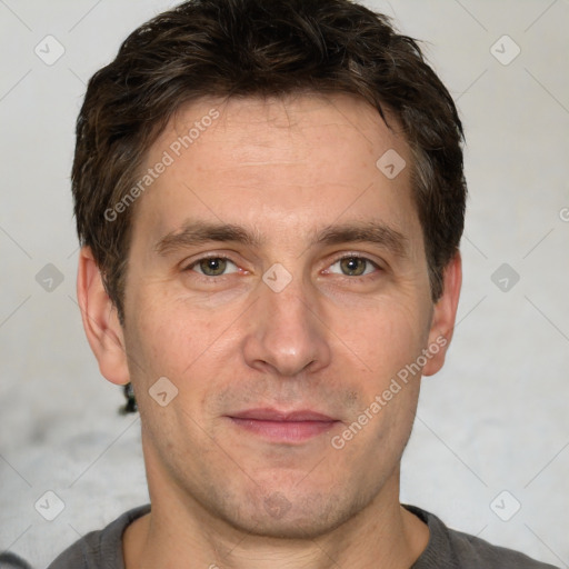 Joyful white adult male with short  brown hair and grey eyes