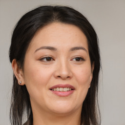 Joyful white adult female with long  brown hair and brown eyes