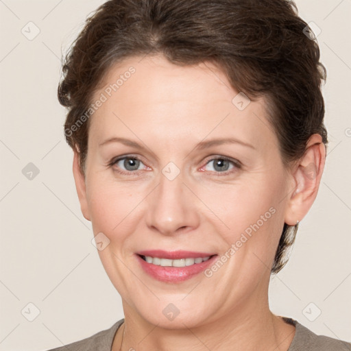 Joyful white adult female with short  brown hair and grey eyes