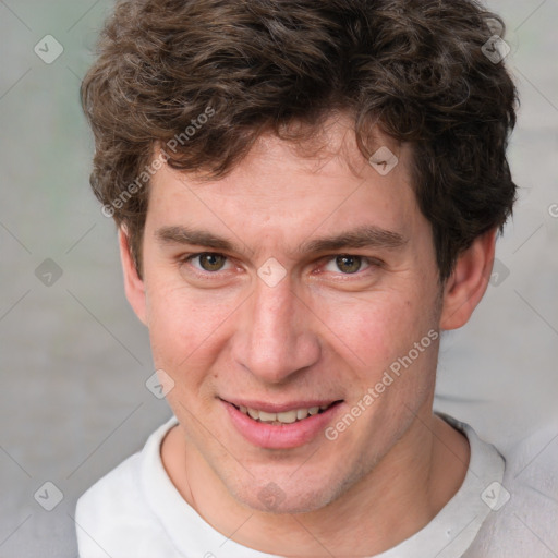 Joyful white adult male with short  brown hair and grey eyes